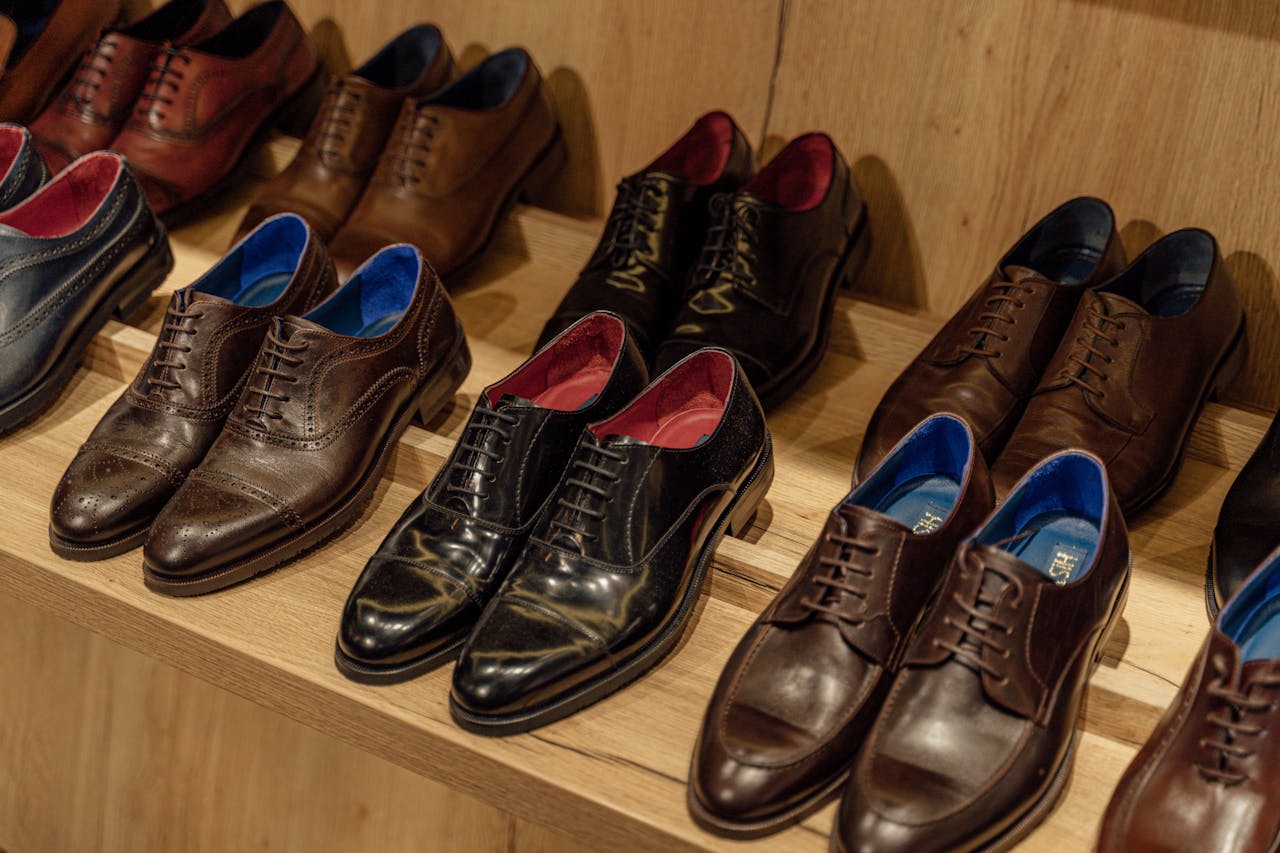 Mastering the First Impression: Your intriguing post title goes here Showcase of elegant leather dress shoes on wooden shelves in-store display.